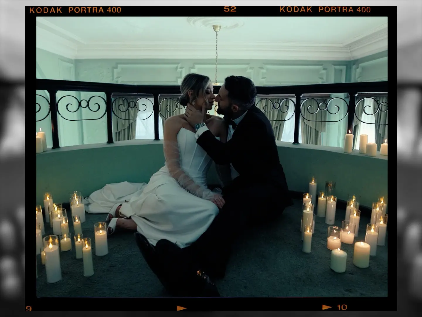 A couple seated among candles