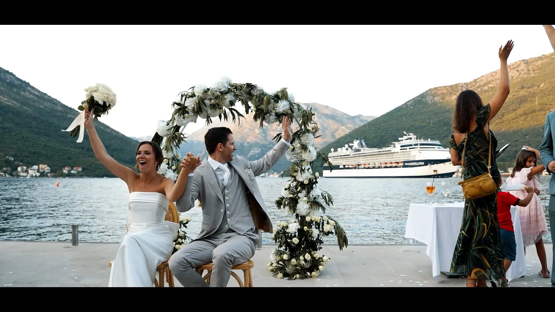 Guests and a couple during a seaside ceremony