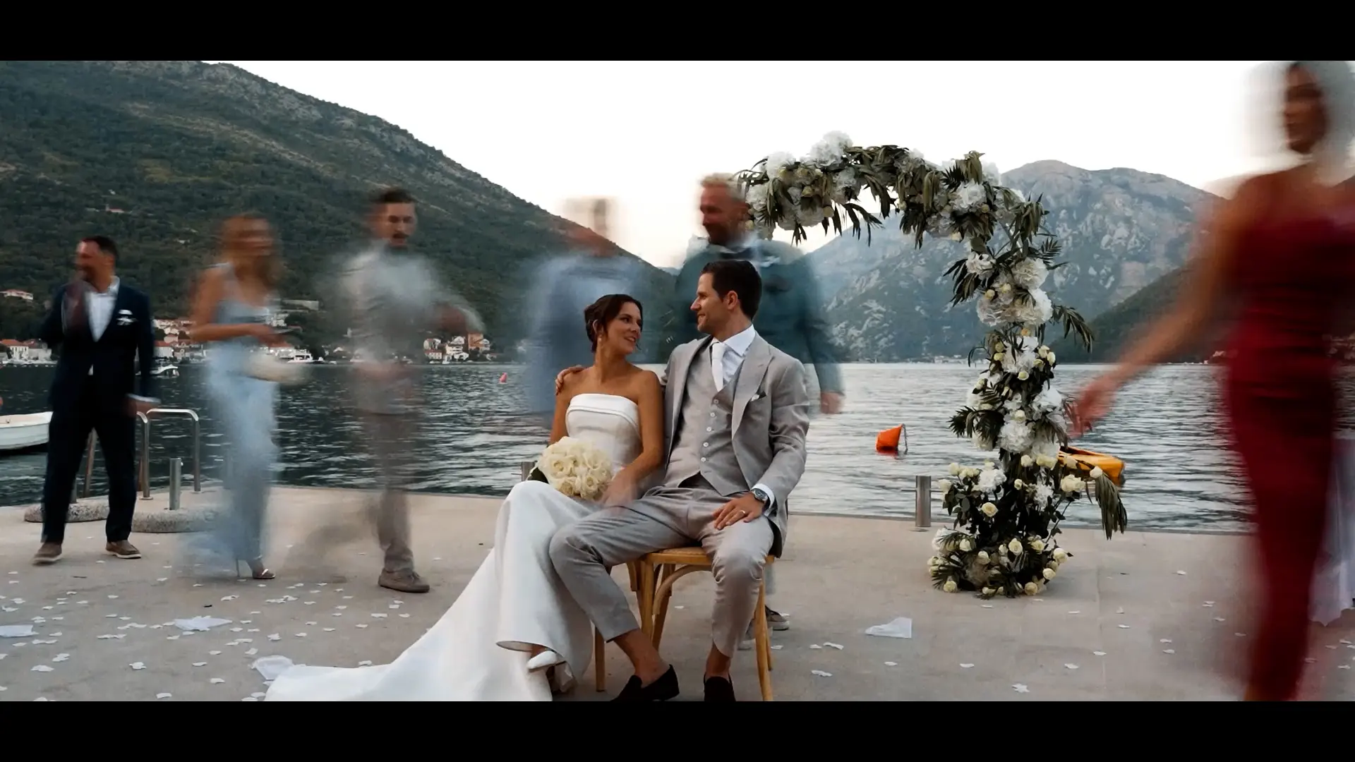 A bride in a vineyard with mountains behind her